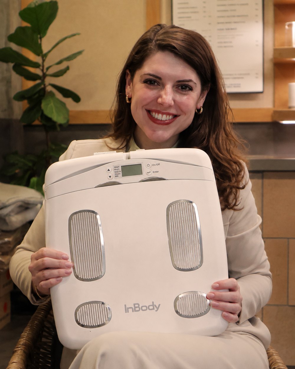 Valpre Huisamen holding an InBody body composition analyser